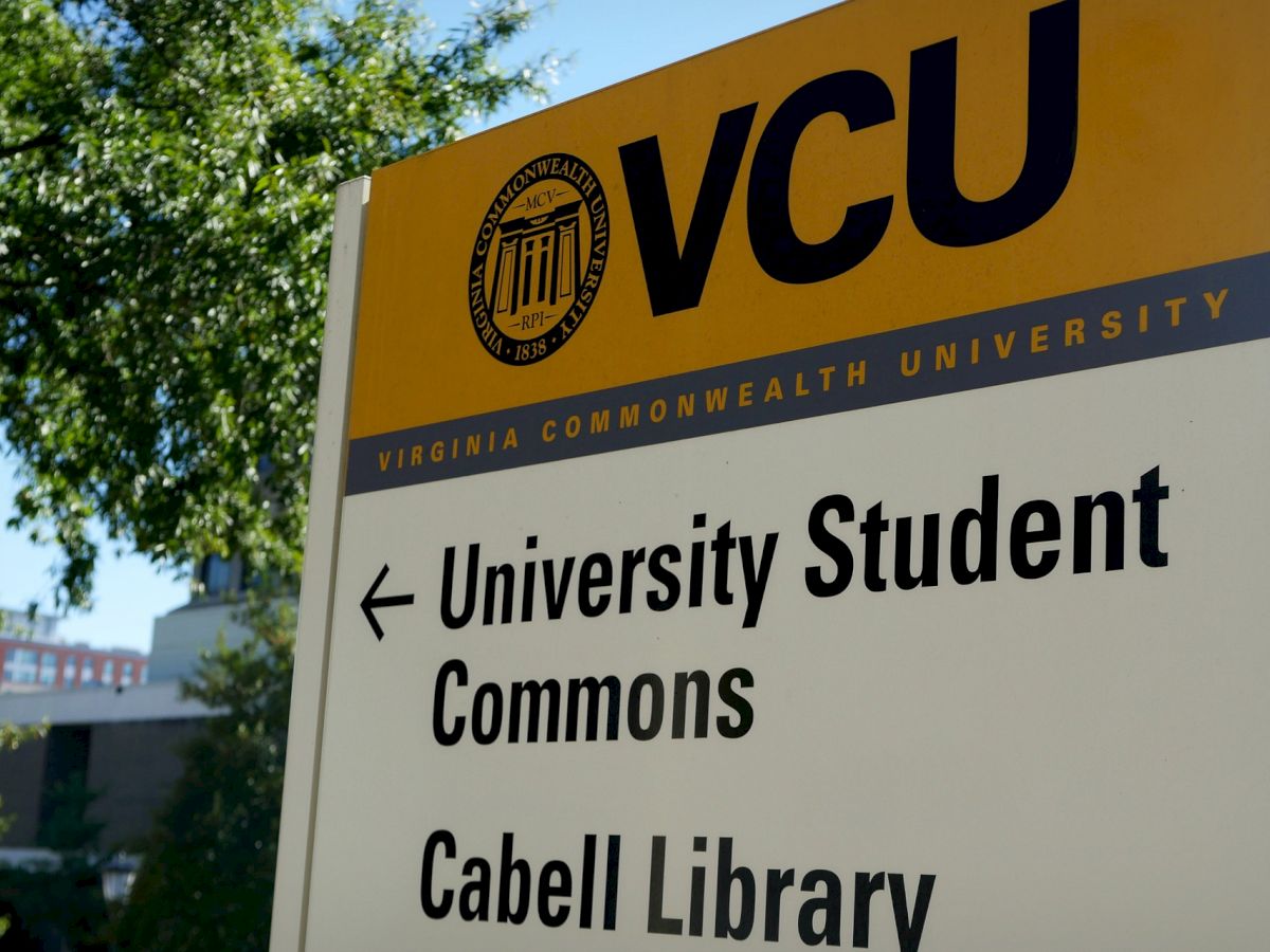 A sign on the campus of Virginia Commonwealth University (VCU) points to the University Student Commons and Cabell Library.